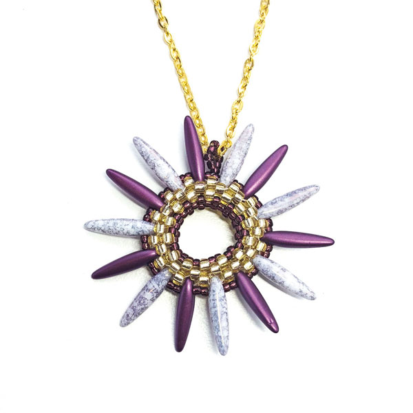 Flamenco Rings - a beading pattern using peyote stitch and thorn beads designed by Chloe Menage. This is a spiky pendant in gold and purple